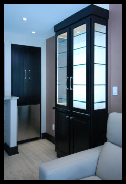 Handcrafted freestanding display cabinets featuring a black base with upper glass doors, LED lighting, and adjustable glass shelving.