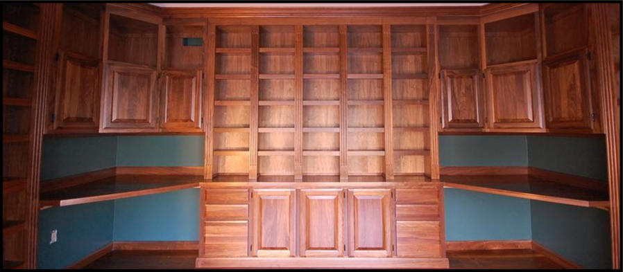 A premier floor-to-ceiling solid wood library masterpiece featuring custom French entry doors, shown in premium Walnut.