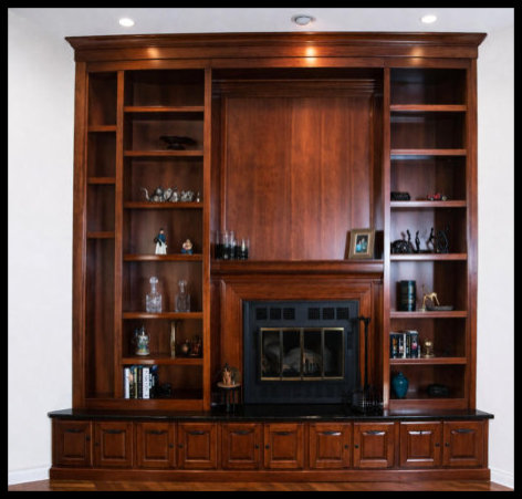 13ft tall cherry fireplace surround with black granite hearth and 10 small cabinetry doors underneath for storage.