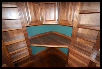 High-end walnut home library with integrated desktop workspace and custom cabinetry. No particle board used.