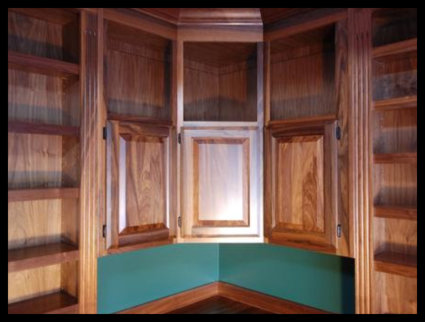Walnut home library built-in with raised-panel cabinetry doors and integrated upper open-face storage. No particle board.