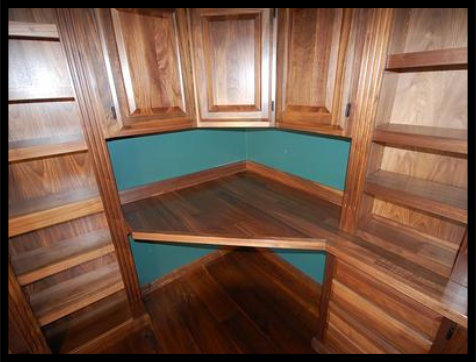 High-end walnut home library with integrated desktop workspace and custom cabinetry. No particle board used.