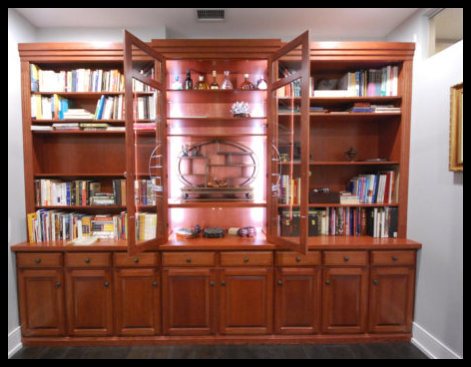 14ft cherry secretary; 8 raised panel doors, 8 drawers, center glass doors with LED lighting, and flanking bookcases.
