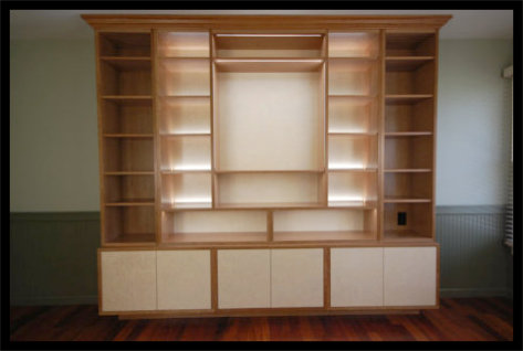 Cherry built-in with inset quilted curly maple doors, hidden hinges, and 4-zone integrated LED lighting; no particle board.