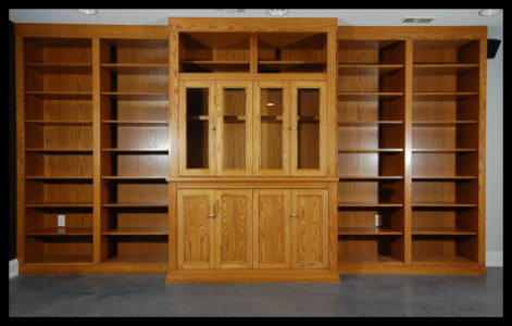 16ft Red Oak entertainment center; Mission style glass and solid doors, with floor-to-ceiling open bookcase bays.