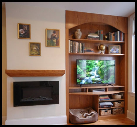 Red Oak entertainment center for wall niche; features integrated dog bed, arched top shelving, and LED player storage.