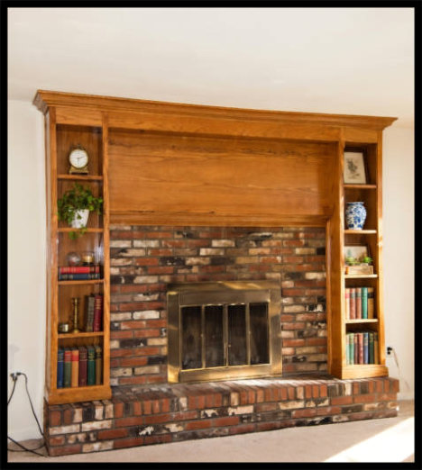 Custom Red Oak fireplace surround on hearth; 8ft wide floor-to-ceiling bookcases with integrated crown molding.
