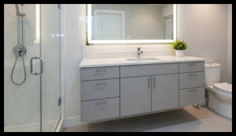 Custom bathroom vanity featuring triple drawer banks on both sides with a central double-door storage cabinet for maximum organization.